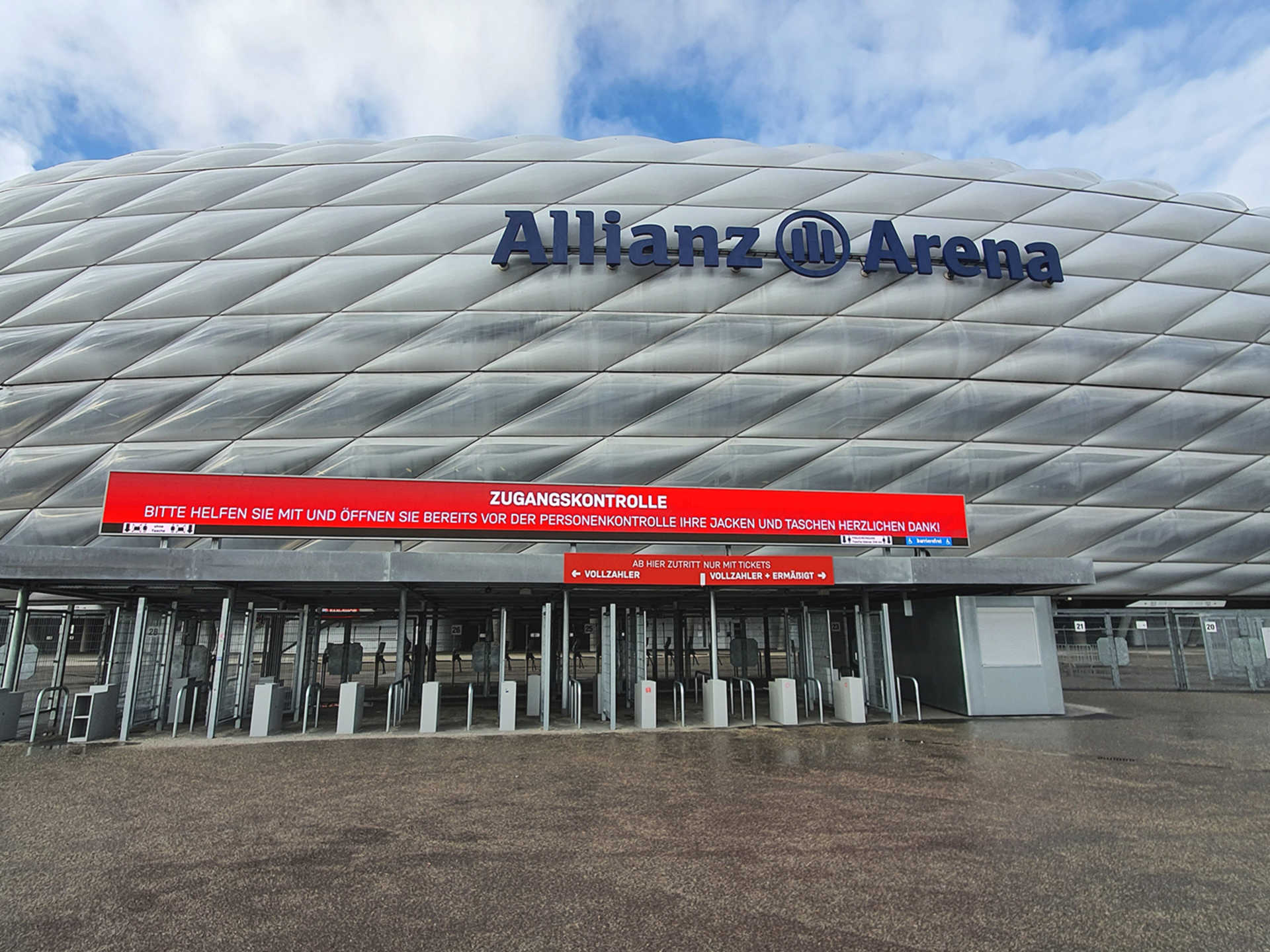 Ticket and security entry turnstiles beneath the Allianz Arena facade