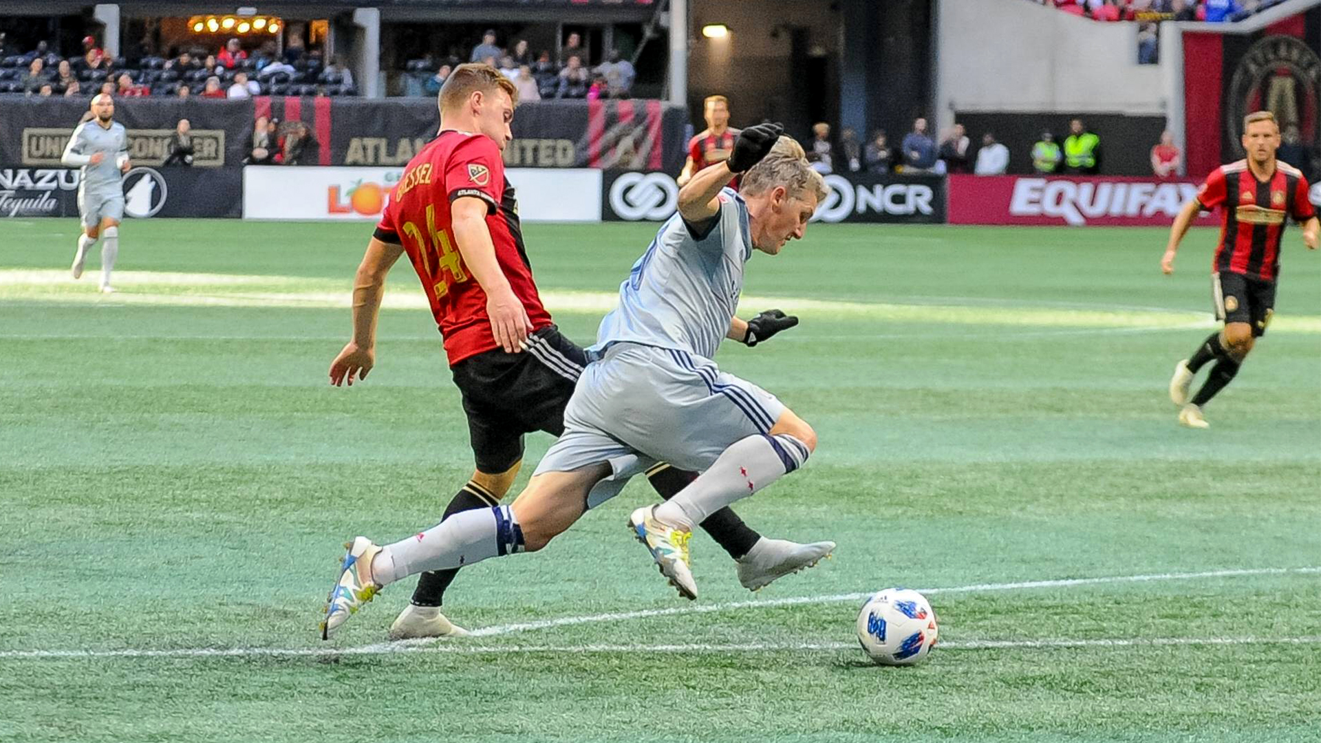 Julian Gressel and Bastian Schweinsteiger tussle in MLS