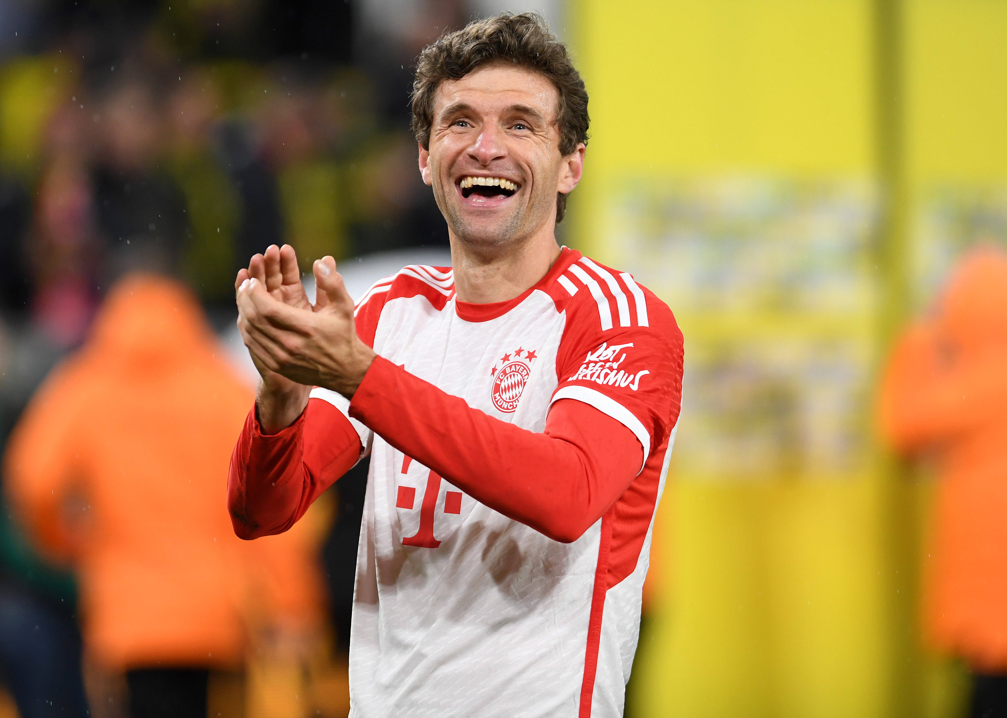 Thomas Müller celebrating after Bayern's victory over Dortmund.