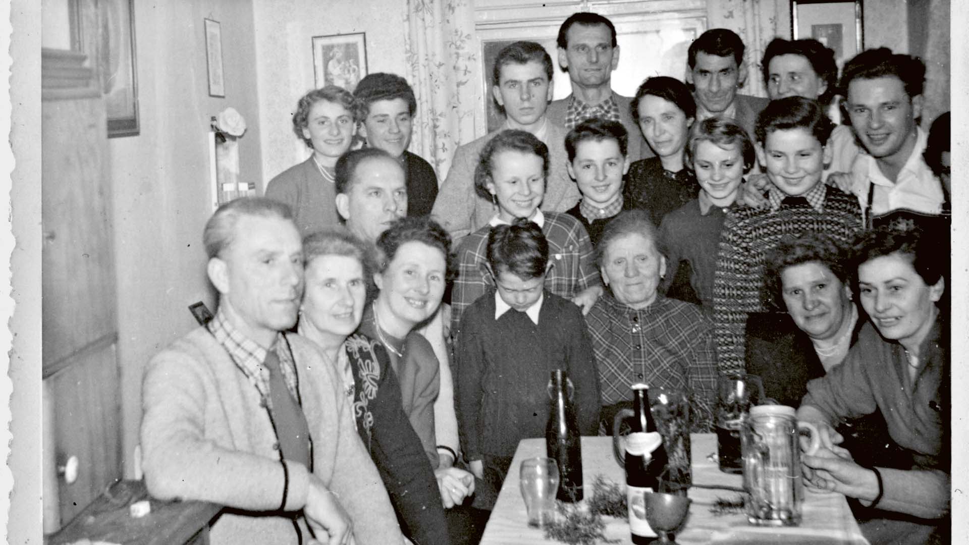 The Beckenbauer family in the living room, Franz with his head sunk between mum and grandma, Walter to his right behind him.