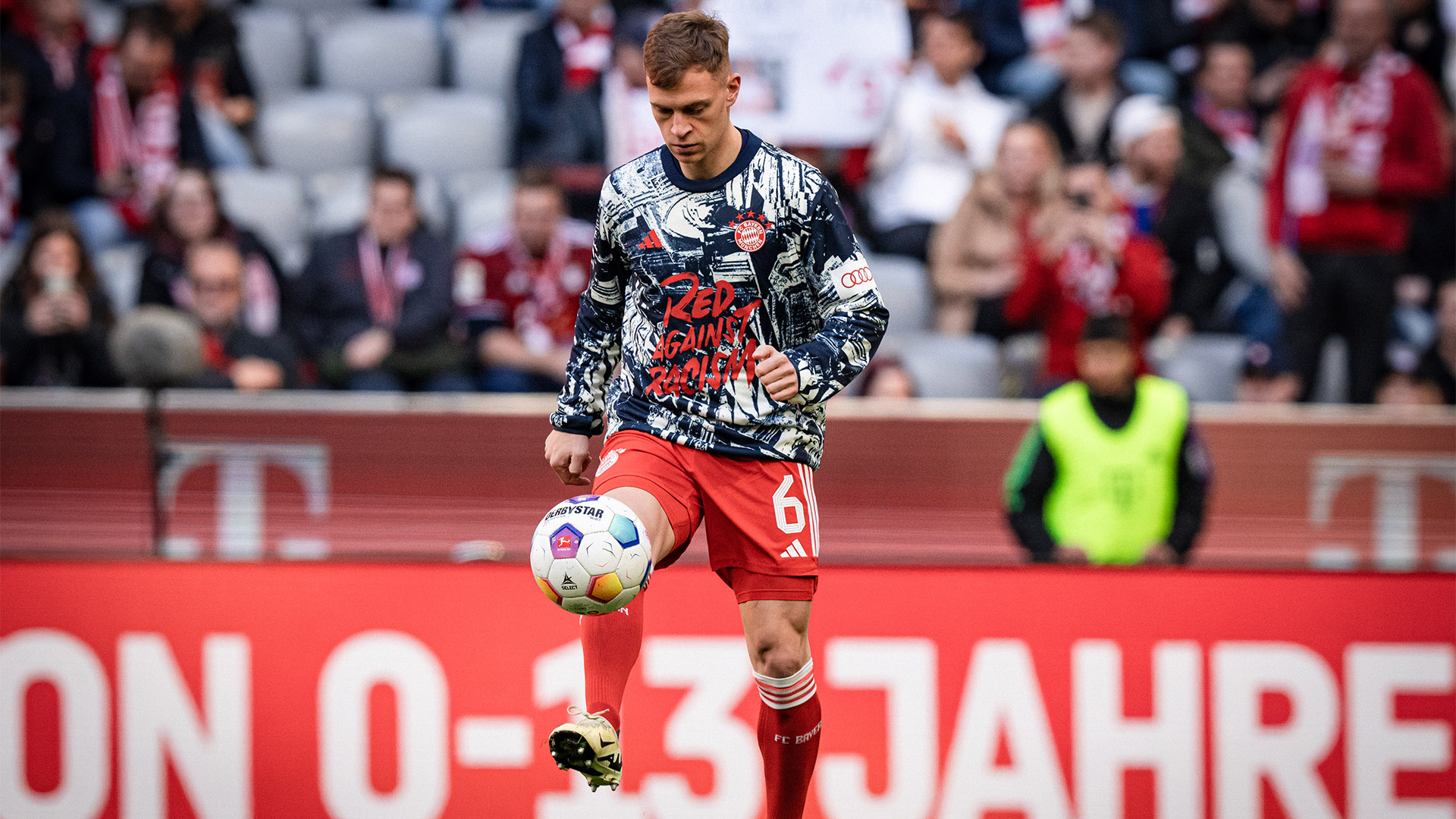 Joshua Kimmich warming up before an FC Bayern Bundesliga match at the Allianz Arena.