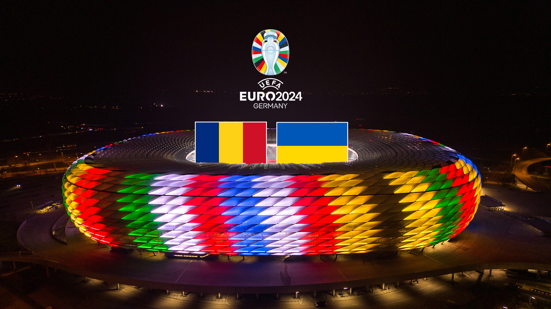 Rumänische und ukrainische Flagge über der Allianz Arena in Sonderbeleuchtung zur UEFA EURO 2024