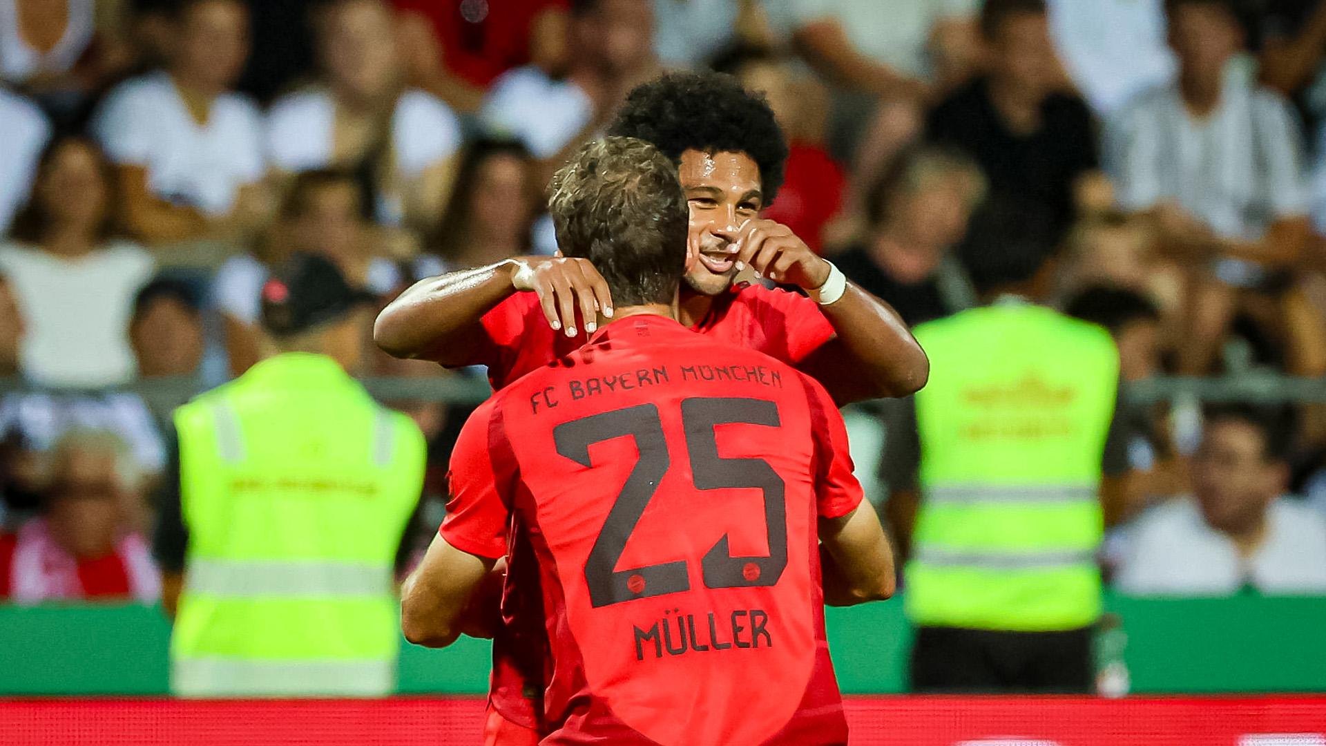 Serge Gnabry celebrates a goal with Thomas Müller.