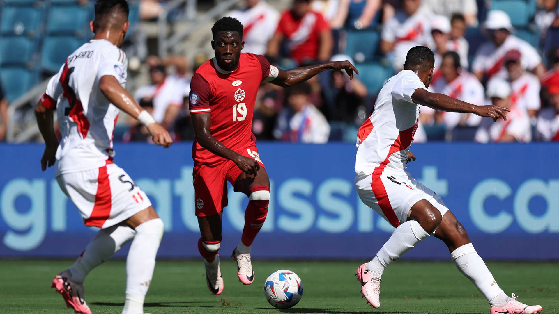 Alphonso Davies con el balón en un partido internacional con la selección canadiense.