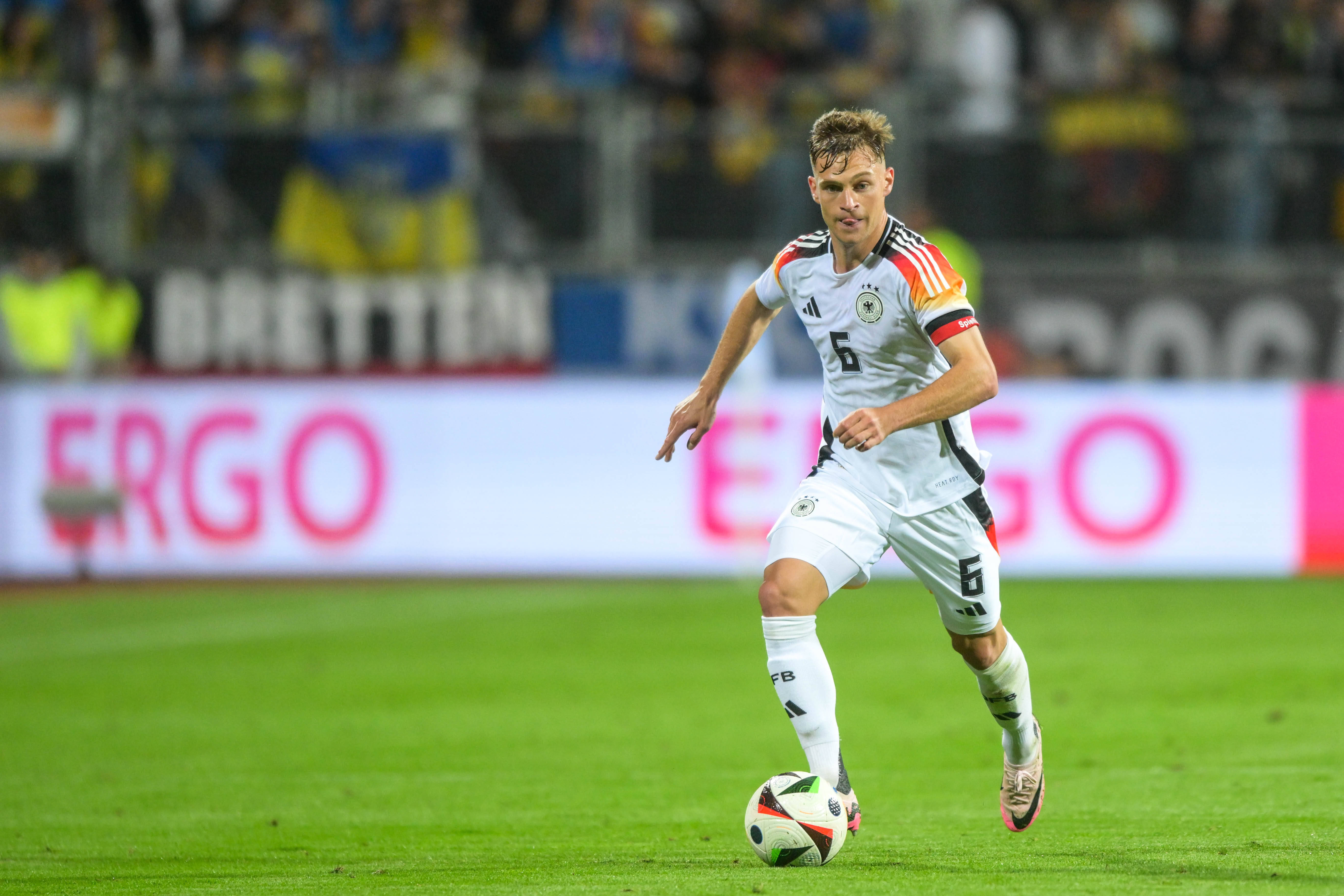 Joshua Kimmich on the ball, wearing the Germany jersey and the captain's armband.