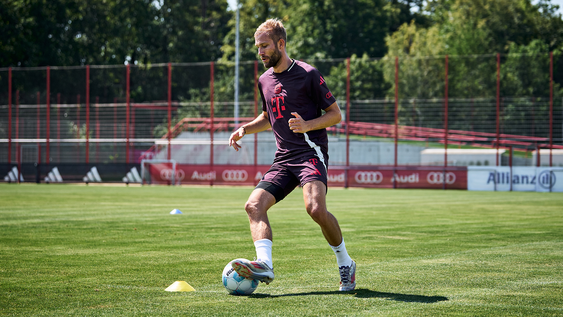 Konrad Laimer umdribbelt mit Ball am Fuß ein Hütchen auf dem Trainingsplatz des FC Bayern.