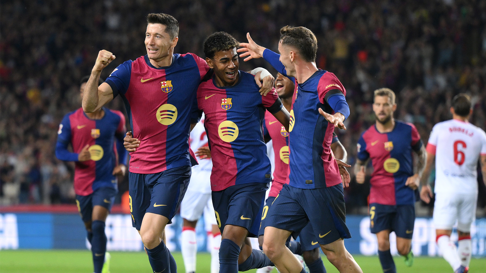 Robert Lewandowski and Lamine Jamal celebrate for Barcelona against Sevilla