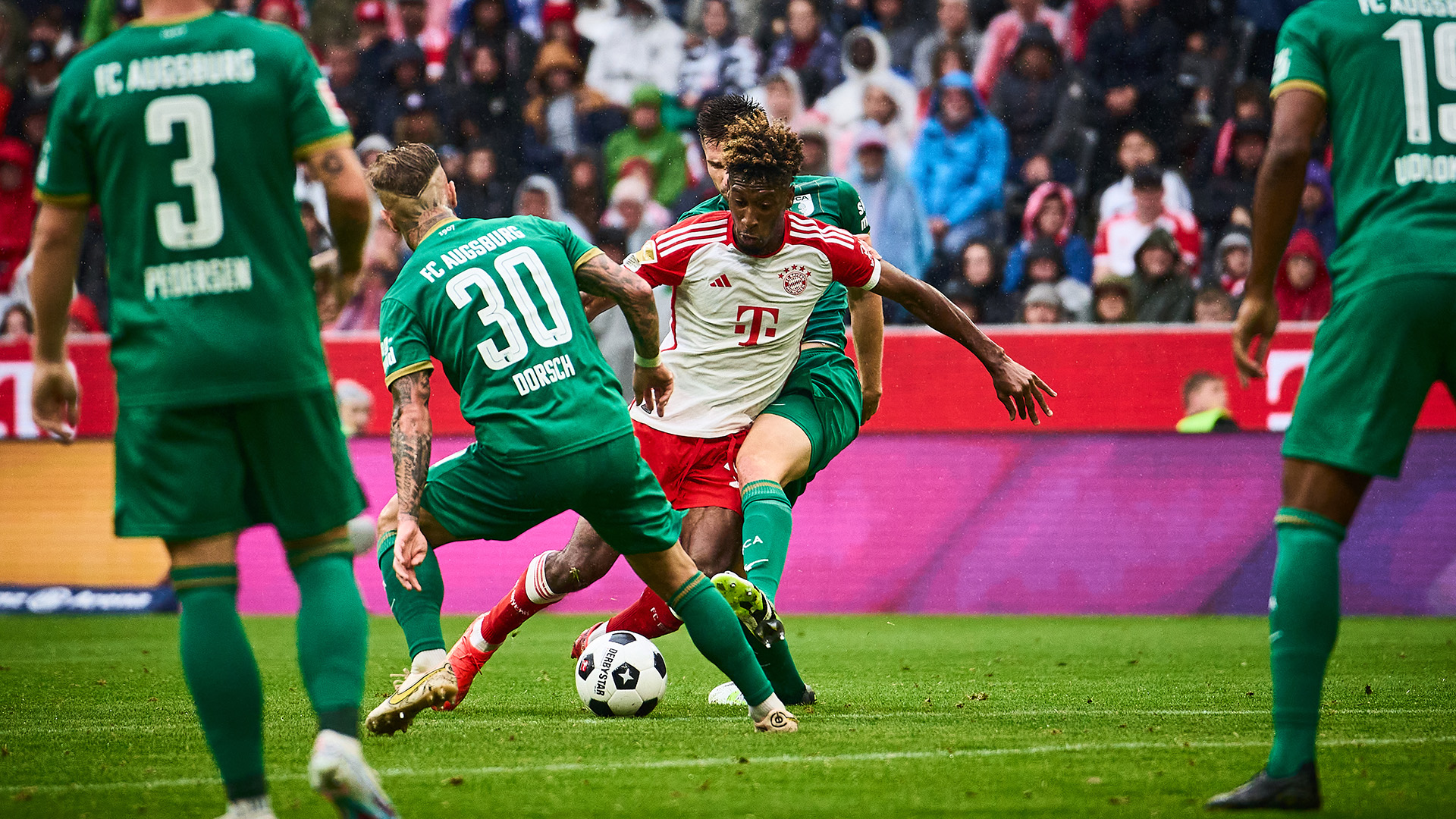 Kingsley Coman being challenged in the match against FC Augsburg