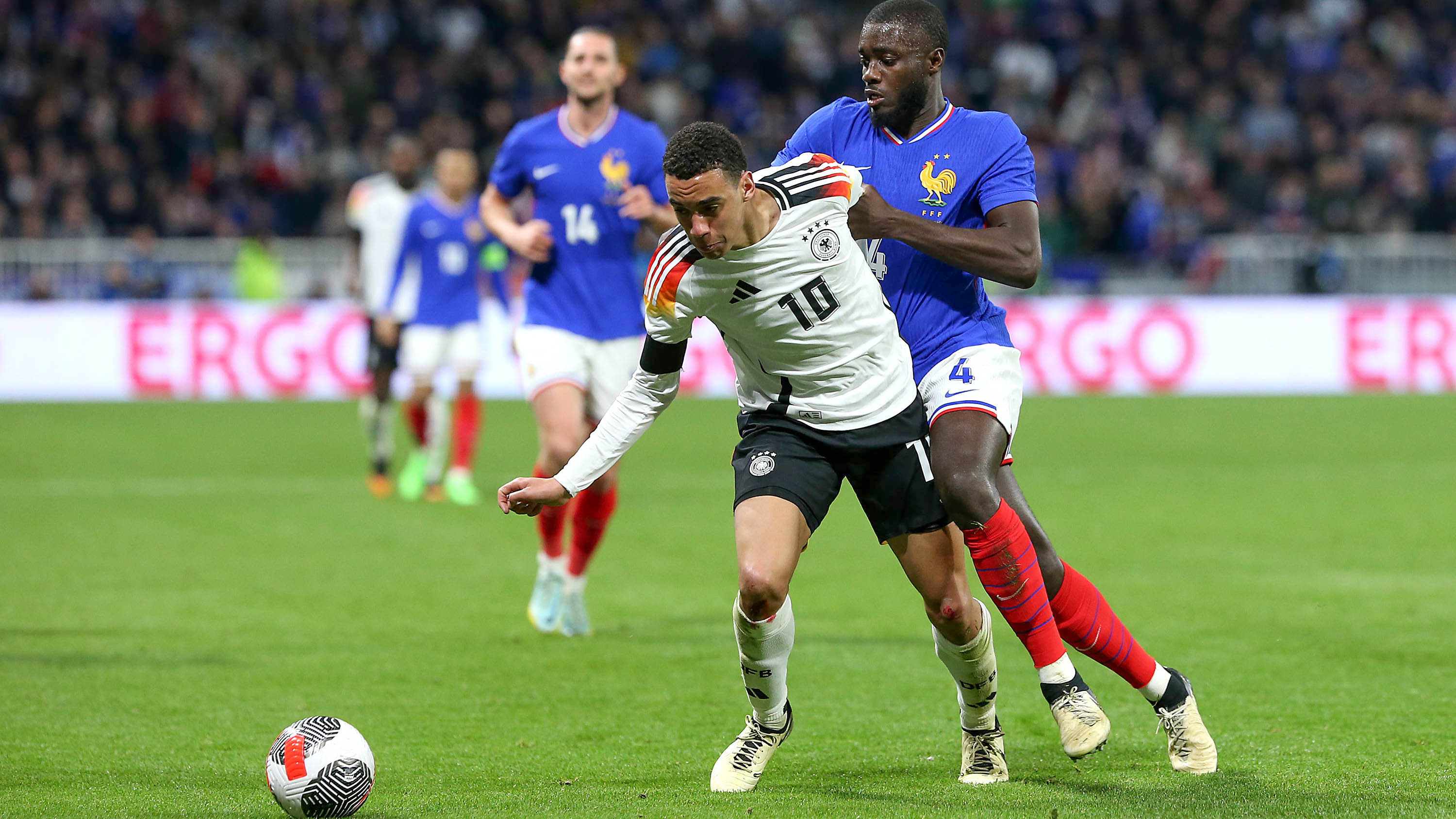 Jamal Musiala for Germany tussles with Dayot Upamecano for France